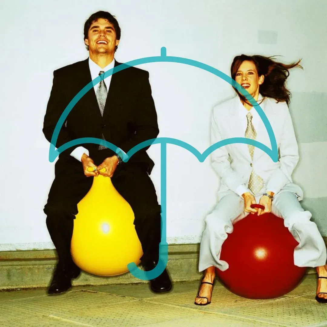 Couple in retro office wear bouncing on yellow and red space hoppers