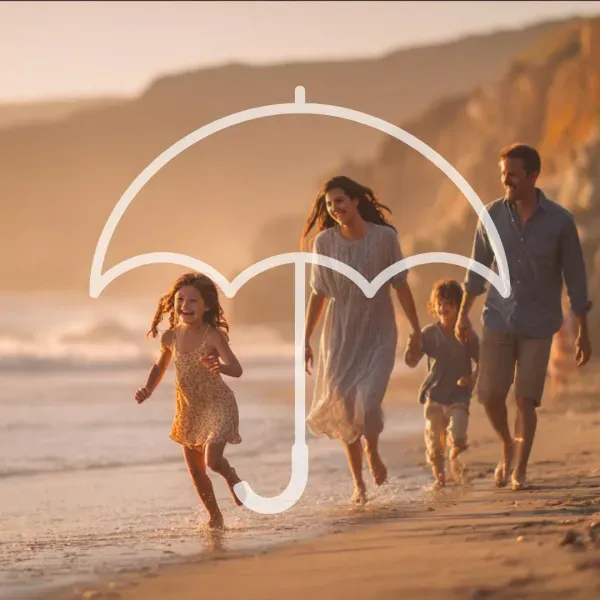 Family running along a beach at sunset